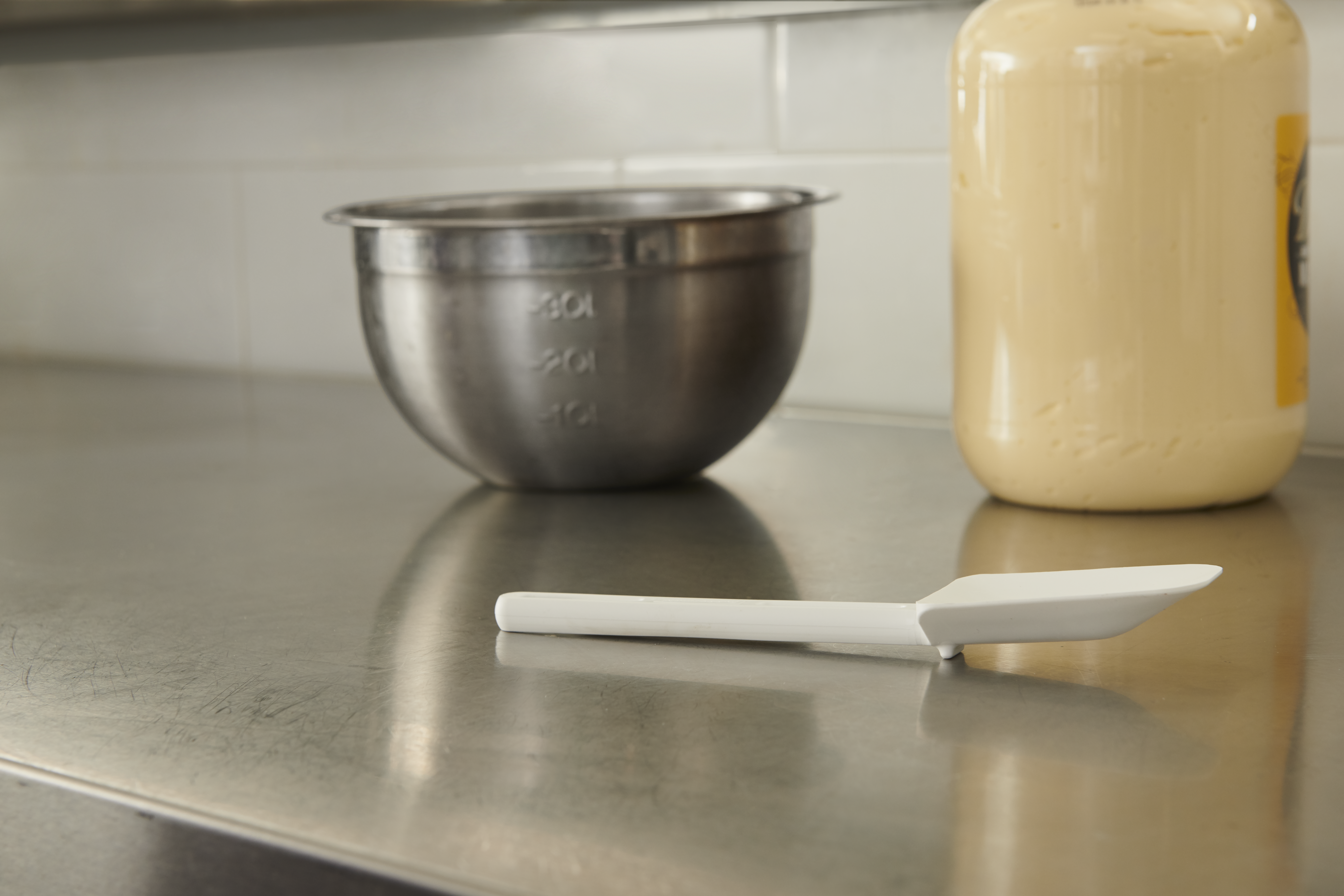 Multi-purpose 9.5" spoon-shaped spatula designed for unheated applications of scraping, scooping, and spreading in food preparation.