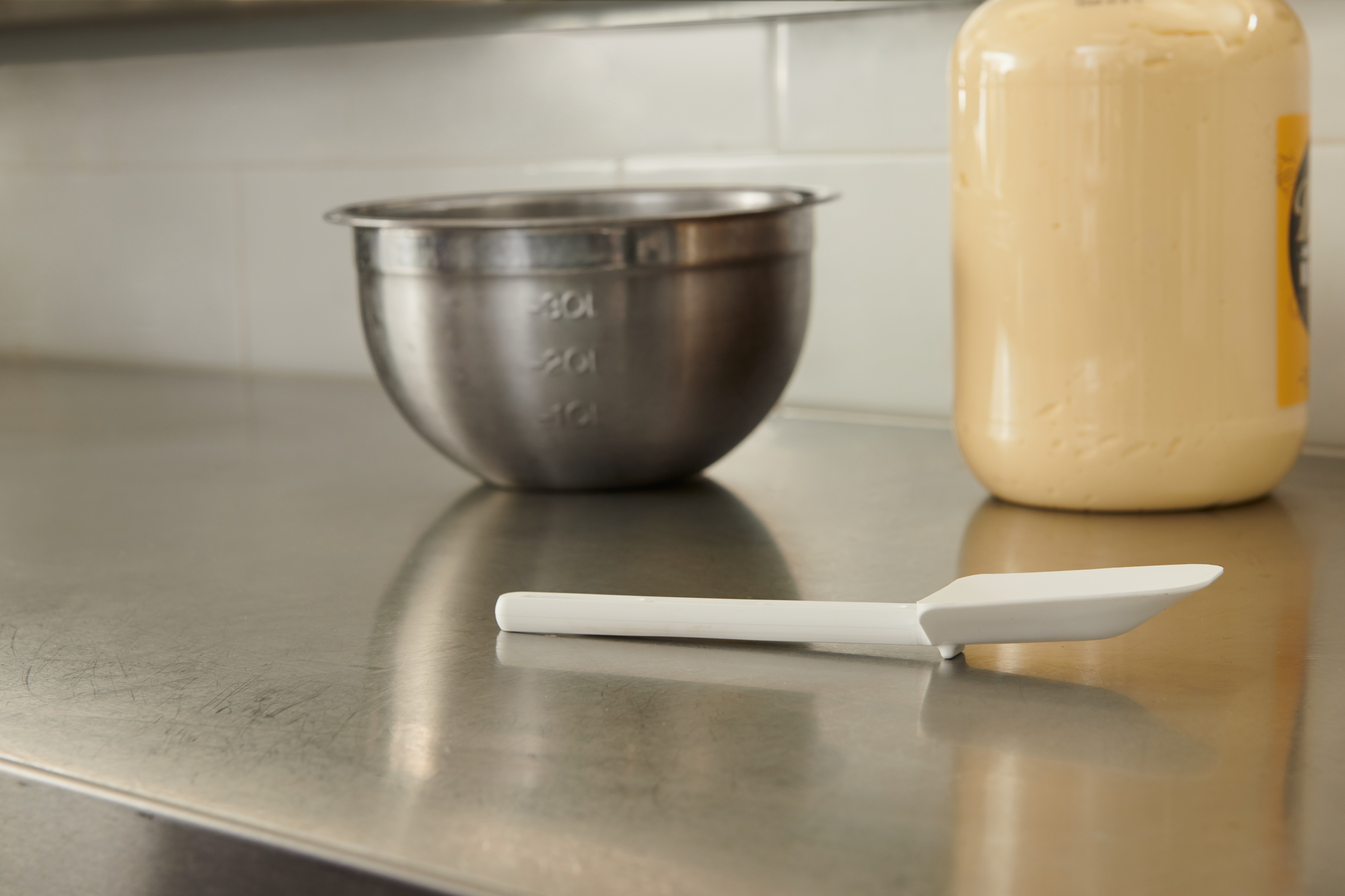 Multi-purpose 9.5" spoon-shaped spatula designed for unheated applications of scraping, scooping, and spreading in food preparation.