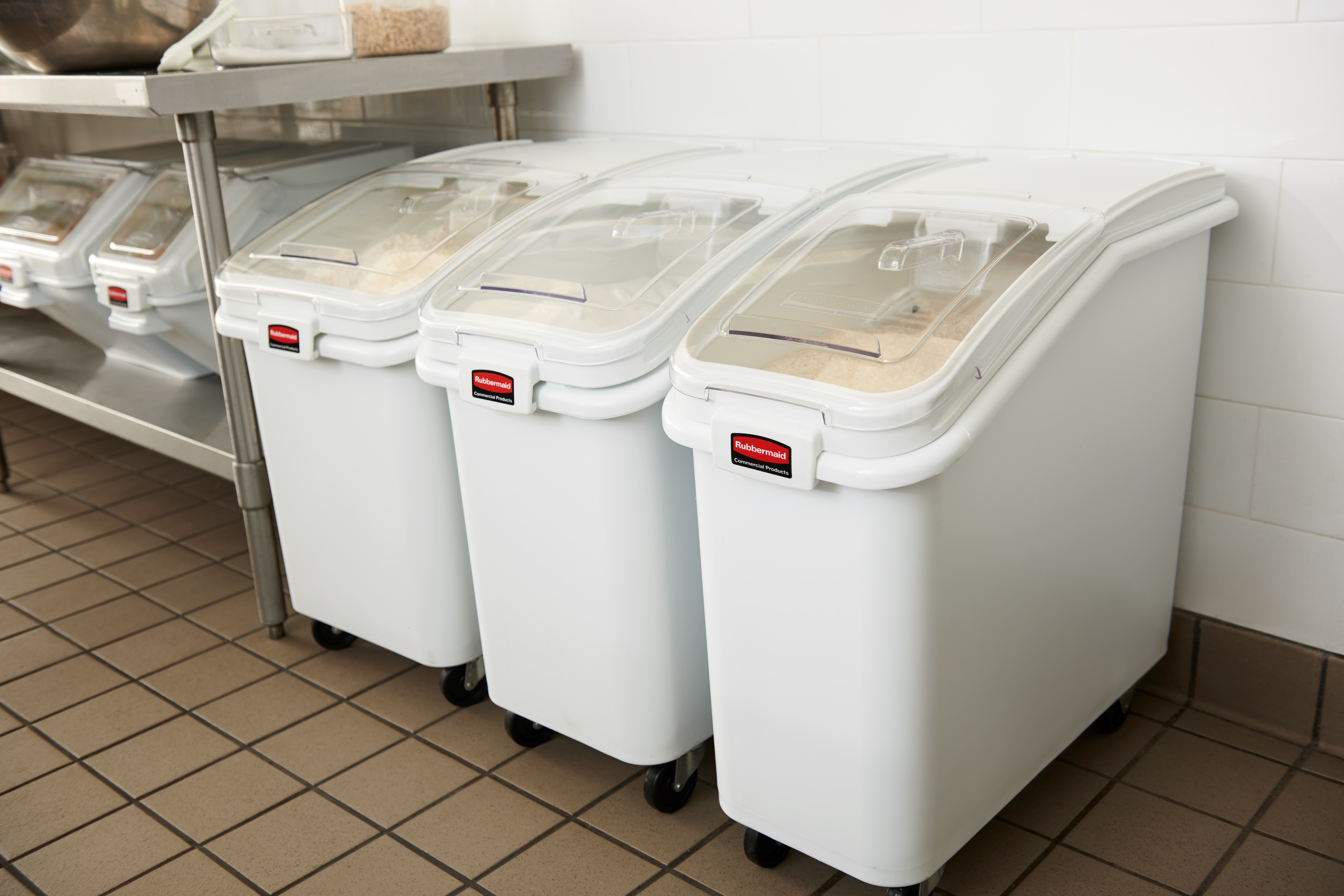 The Rubbermaid Commercial ProSave® Ingredient and Food Storage Mobile Bin is a bulk food storage container on wheels. With a slanted front, sliding opening, and 32-ounce scoop, these food storage containers make it easy to transport ingredients.