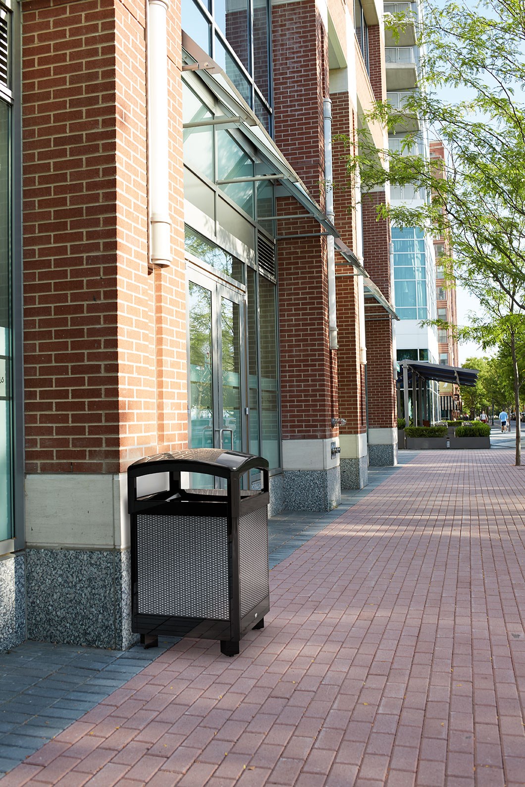 The Dimension Series decorative outdoor waste container's perforated steel panels create an upscale, dimensional look that complements contemporary outdoor enviornments.