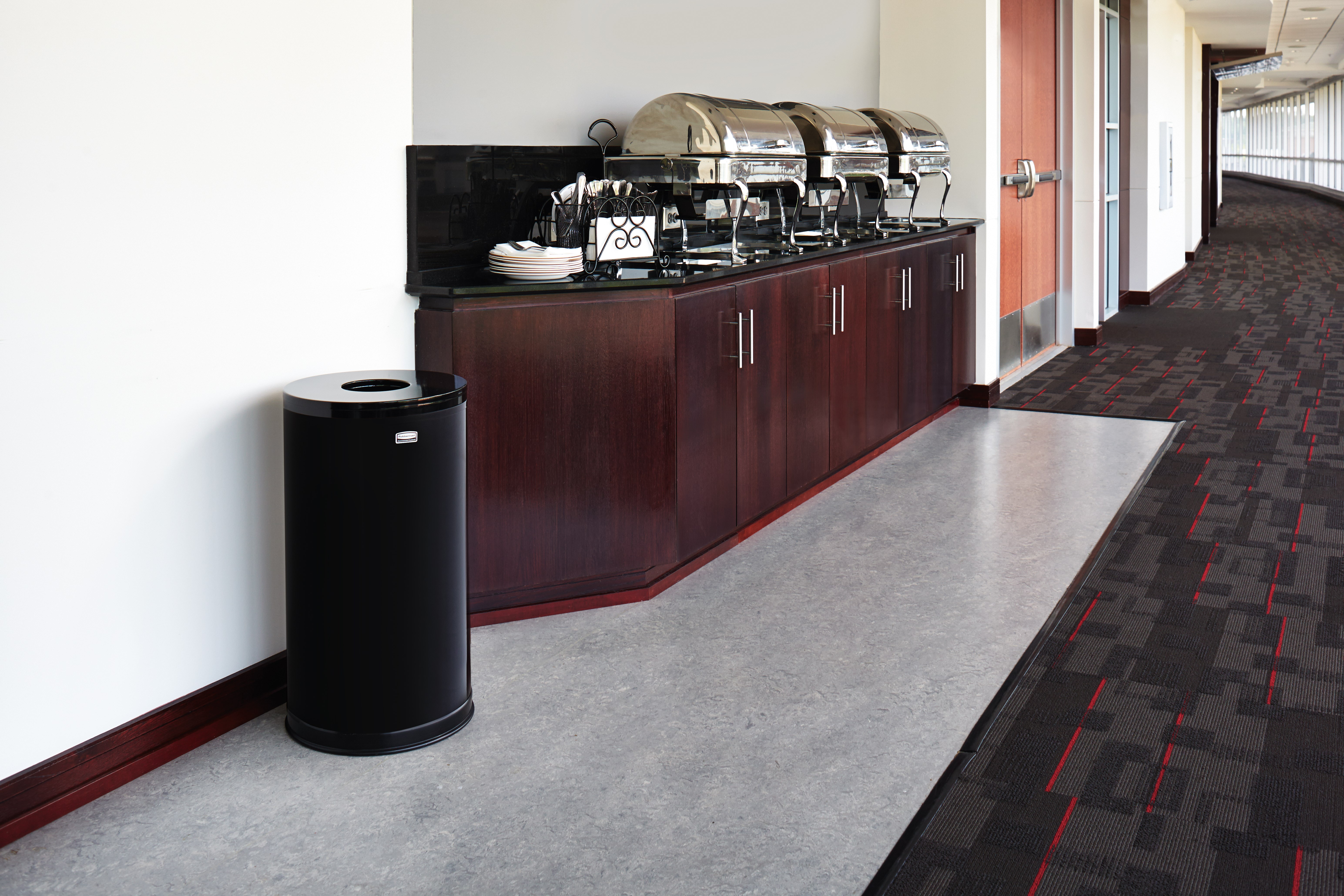 The Metallic Series 15 Gallon FGCC16 Indoor Waste Container has a sleek design that blends nicely with upscale interiors.
