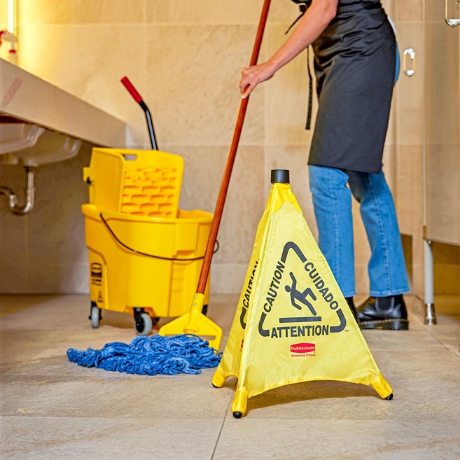 Collapsible sign automatically deploys when removed from wall-mounted storage tube. Multilingual safety communication utilizes ANSI/OSHA-compliant color and graphics