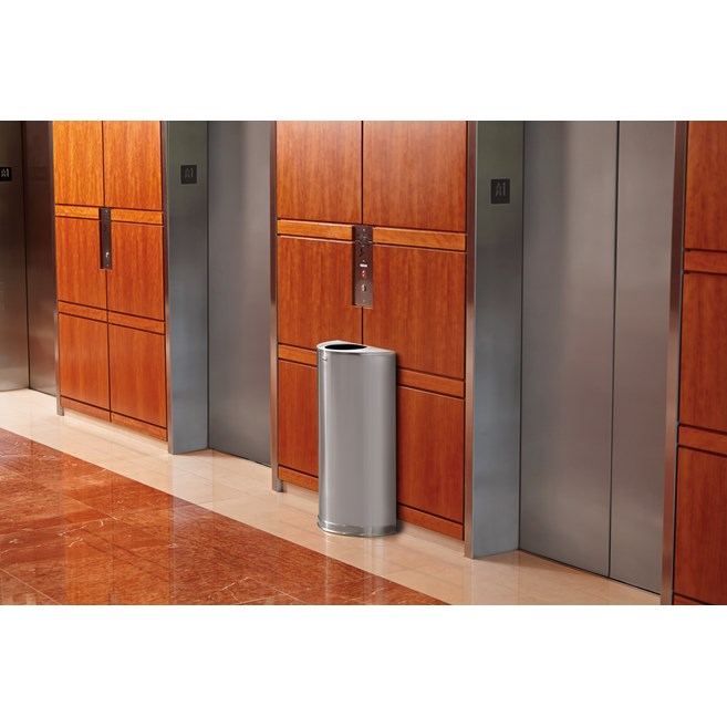 The Half Rounds Series indoor decorative waste container fits flush against walls to conserve space and reduce obstructions in high-traffic areas. The sleek and functional design of this receptacle blends seamlessly with upscale and modern indoor facilities.