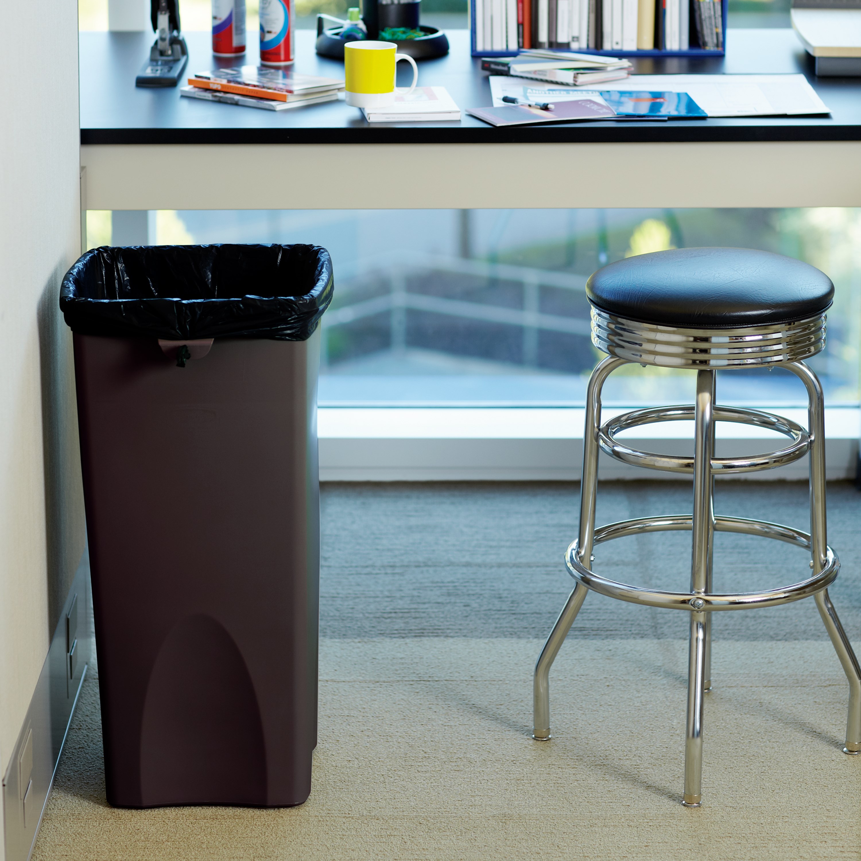 Stationary containers provide convenient central collection sites for multiple work stations or areas.