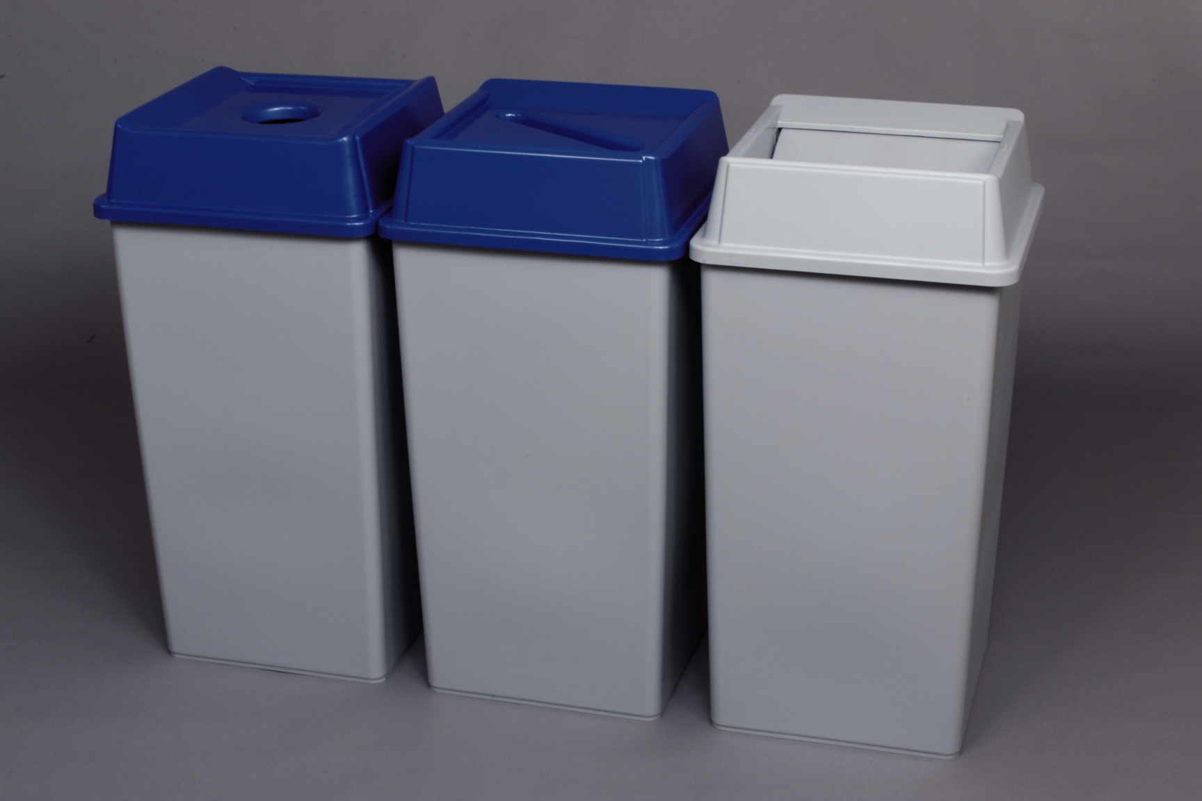 Stationary containers provide convenient central collection sites for multiple work stations or areas.