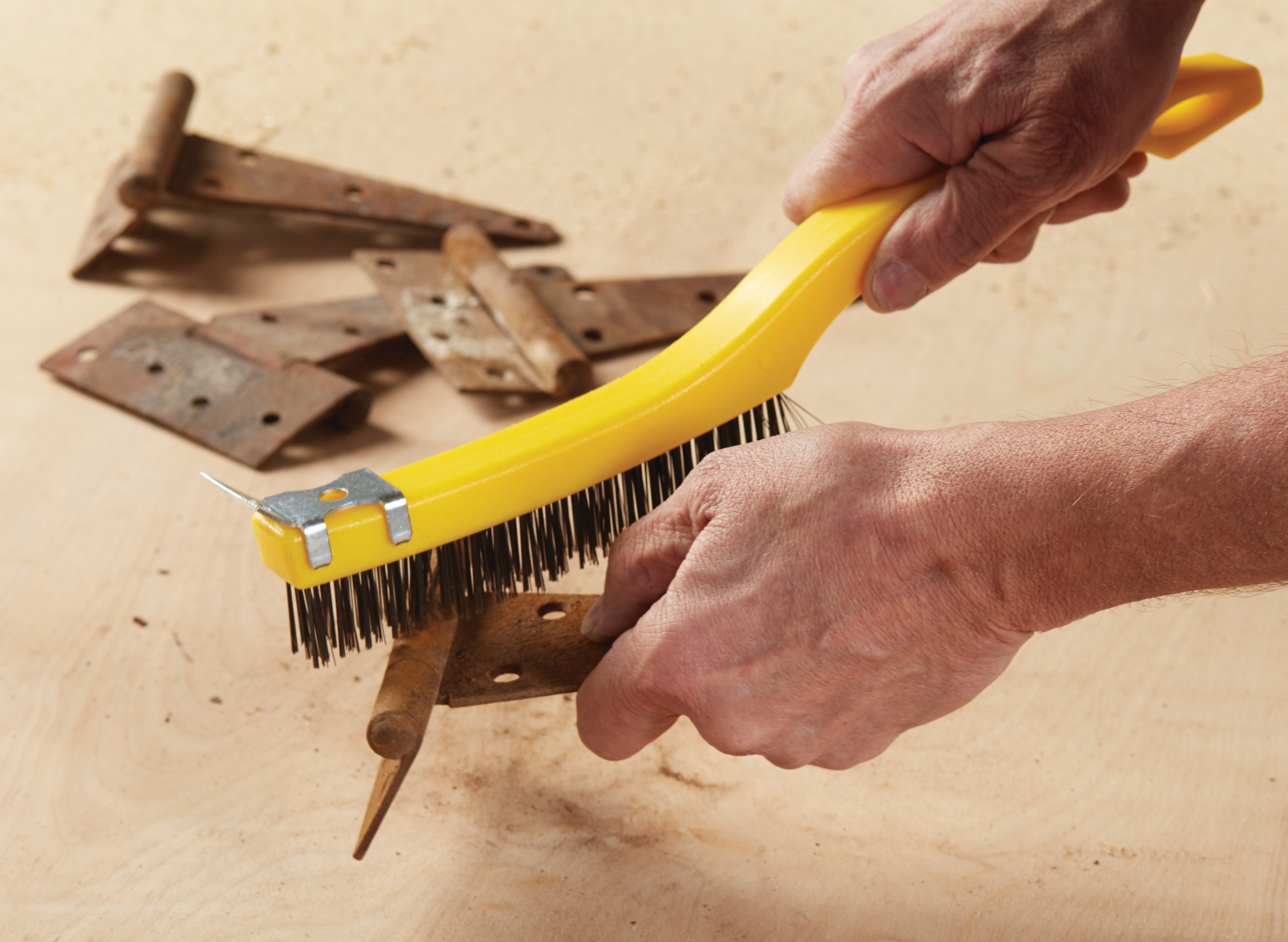 This brush has steel wire bristles. Long plastic handle. Includes a scraper for those needing extra cleaning power. 14-inch length, 3-inch by 19-inch bristle pattern.