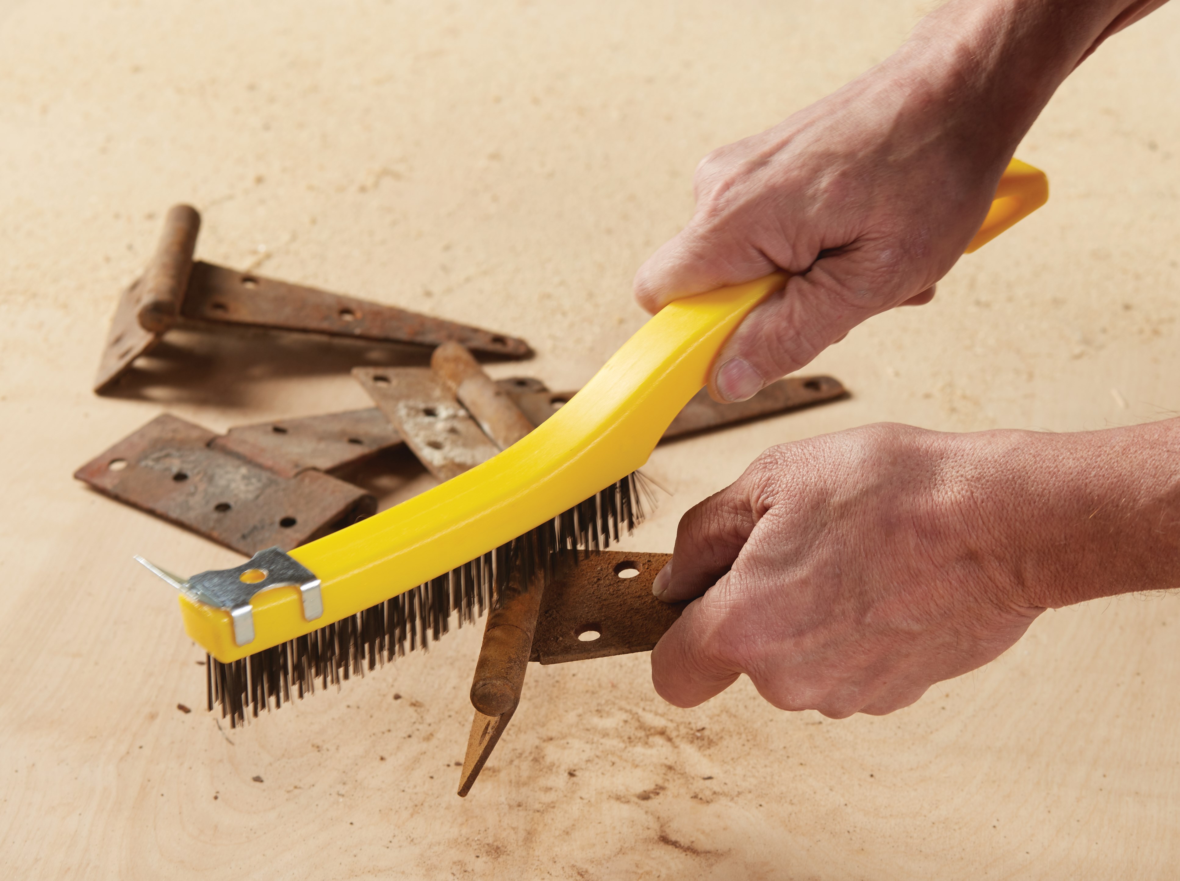 This brush has steel wire bristles. Long plastic handle. Includes a scraper for those needing extra cleaning power. 14-inch length, 3-inch by 19-inch bristle pattern.